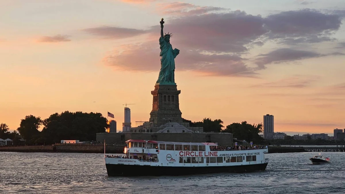 The Harbor Lights Cruise at dusk with the Statue of Liberty in the background