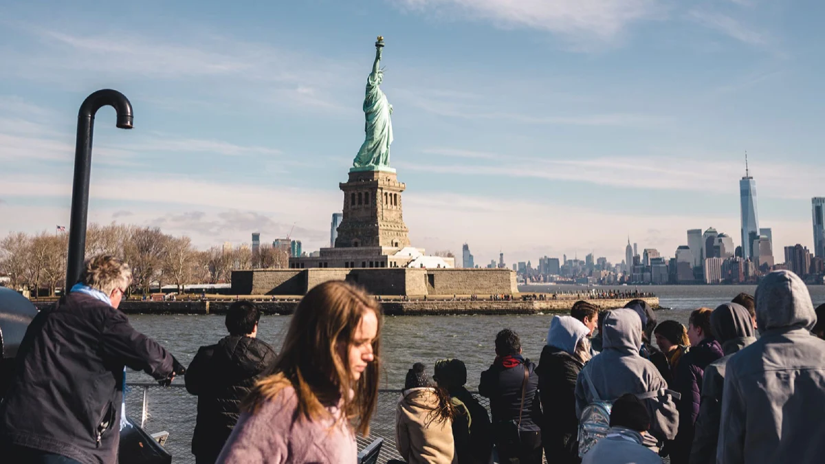 Visitors nearing Liberty Island on the first ferry of the day