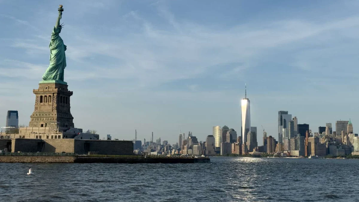 Liberty Statue and NYC skyline on a bright day