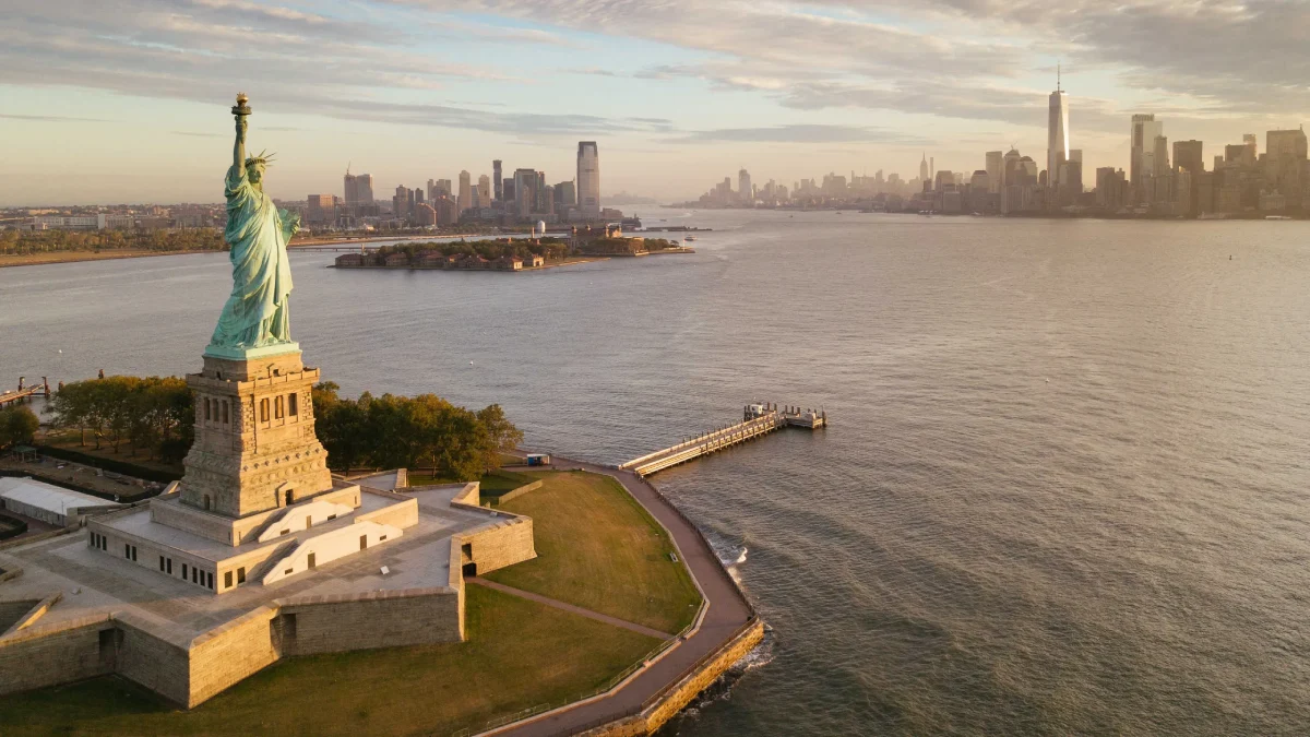 Aerial view of Liberty Statue with Ellis Island and New York skyline in the backdrop