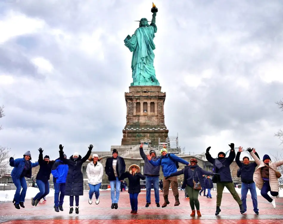 Visitors posing behind the Liberty Statue